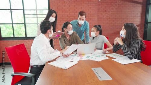 Multi ethnic business people in face mask meeting new normal in office