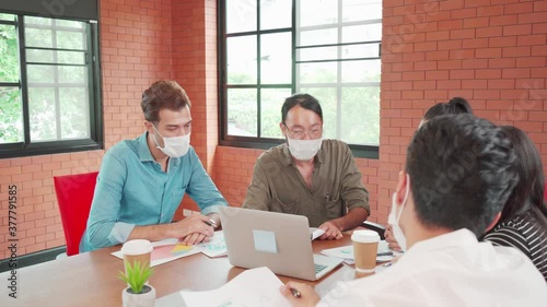 Multi ethnic business people in face mask meeting new normal in office