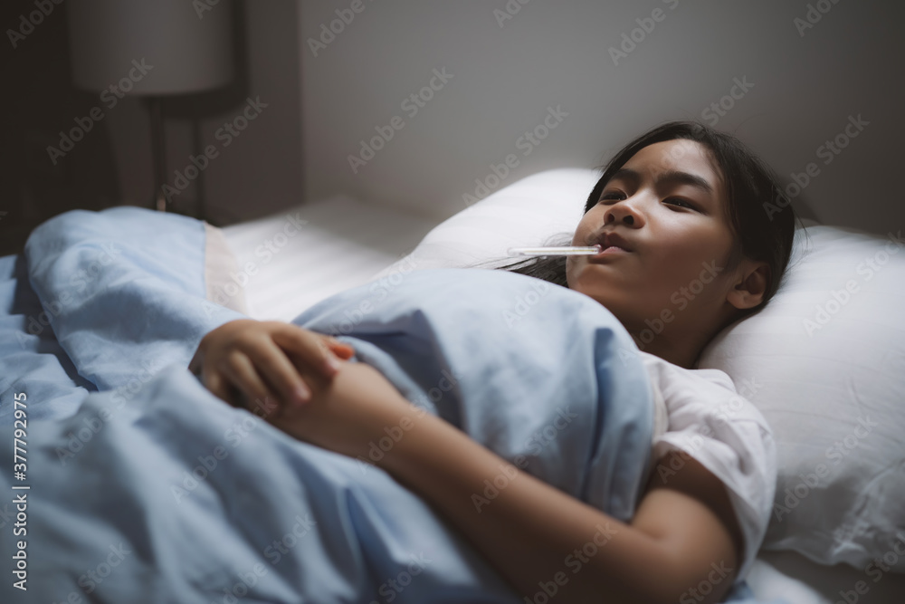 Sick daughter covered with a blanket lying in bed with high fever and a flu. Sick daughter covered with a blanket lying in bed with high fever and a flu.
