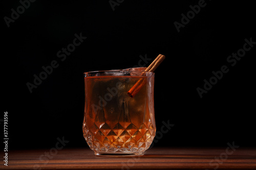 Obraz na plátně Cinnamon Old Fashioned cocktail on a walnut bar table