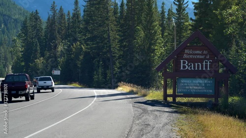 Establishing shot showing welcome sign with mask wearing advisory due to Covid-19 pandemic at the entrance of Banff town in Alberta, Canada.
