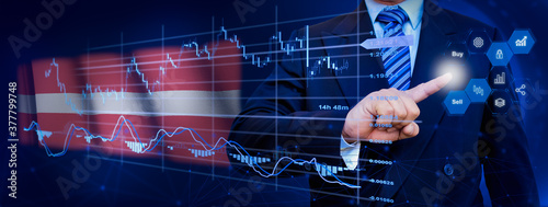 Businessman touching data analytics process system with KPI financial charts, dashboard of stock and marketing on virtual interface. With Latvia flag in background. © TexBr
