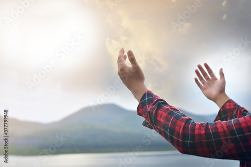 Christian woman hands praying to god on the mountain background with morning sunrise