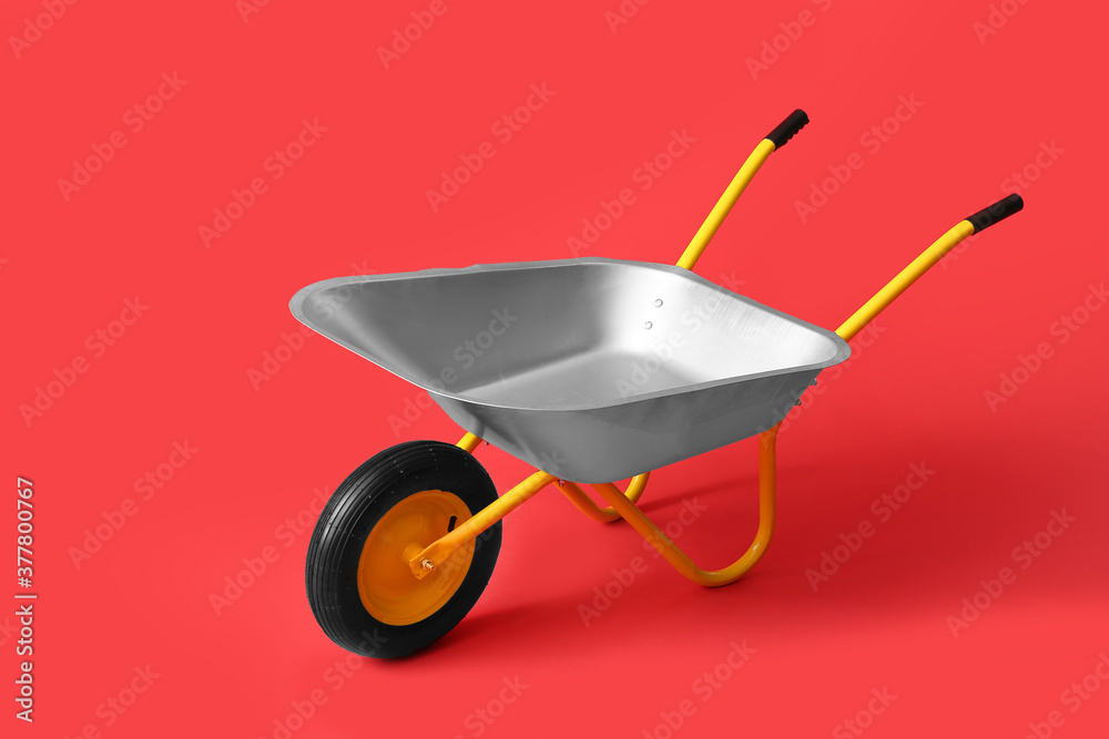 Empty wheelbarrow on color background Empty wheelbarrow on color background
