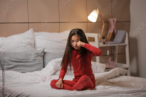 Little girl suffering from sleep disorder in bedroom photo