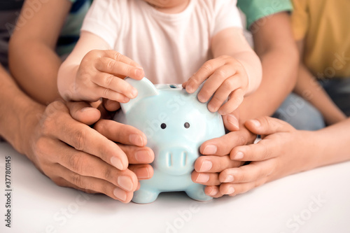 Family with piggy bank at table