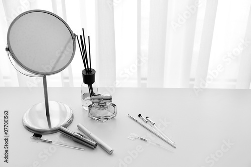 Fototapeta Set of decorative cosmetics and mirror on dressing table