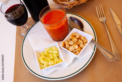 Gazpacho in glass spanish tomato based cold vegetable soup served with cucumbers and baked bread