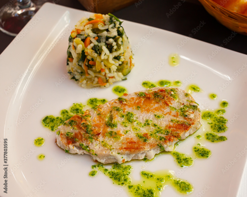 Image of tasty grilled tuna with garlic and parsley, served with rice