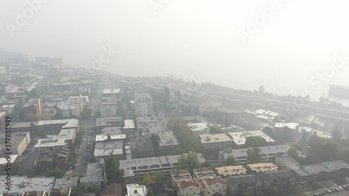 Aerial / drone footage of the Seattle Center, waterfront, piers, Belltown, Elliott Bay, Puget Sound with smoke in the air from the Washington State wildfires in Seattle, Washington photo