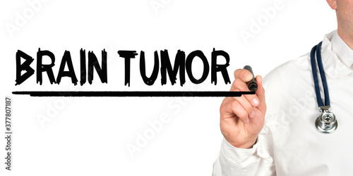 Doctor writes the word - BRAIN TUMOR. Image of a hand holding a marker isolated on a white background.