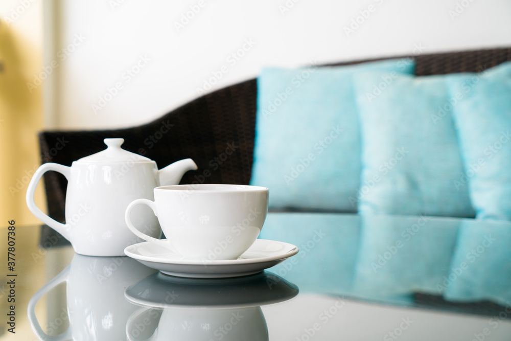 tea cup with teapot on table tea cup with teapot on table