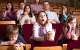 Spectators attending movie night with popcorn in cinema house
