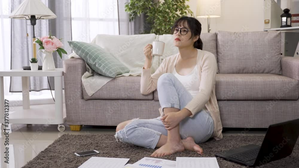 korean female freelance having hot drink is taking a short break from work. beautiful asian lady touching neck while looking afar is in contemplation of how to deal with the project. korean female freelance having hot drink is taking a short break from work. beautiful asian lady touching neck while looking afar is in contemplation of how to deal with the project.