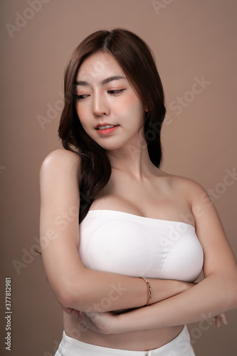 Asian beauty woman with natural makeup, cosmetic and plastic surgery concept, Isolated mocha brown background