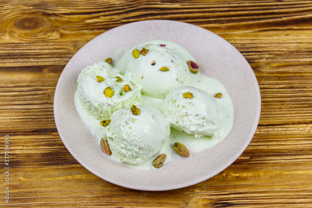 Pistachio ice cream on wooden table Pistachio ice cream on wooden table