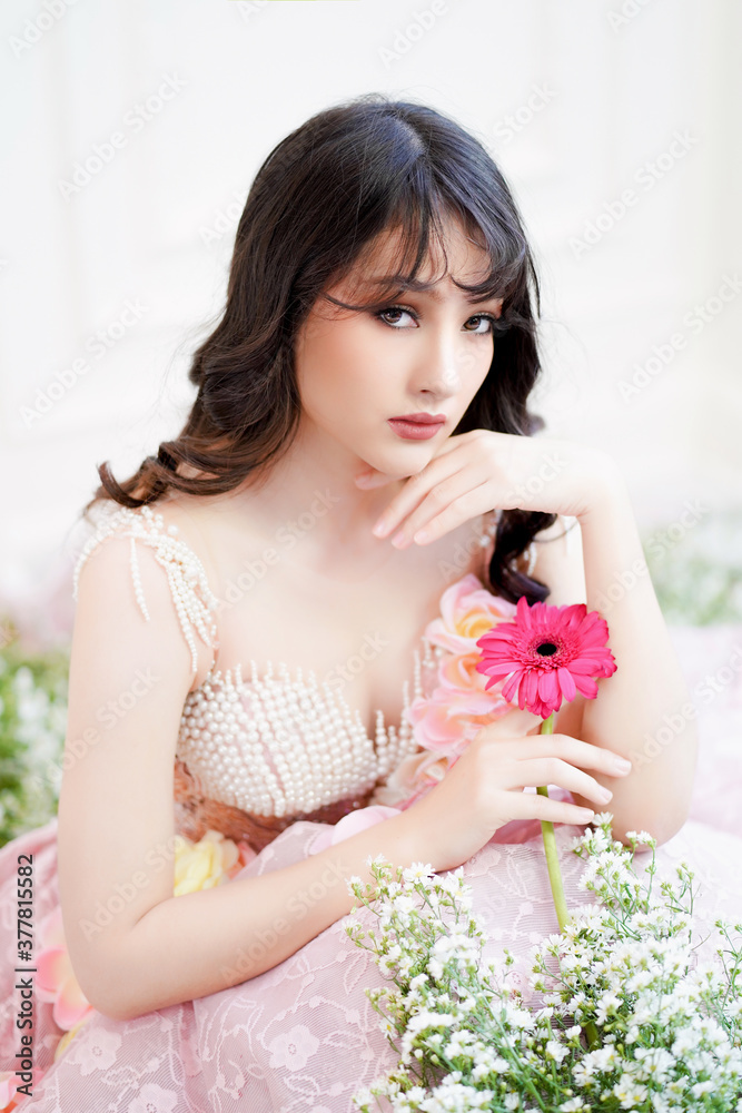 Indian woman relaxing with good smell of Gerbera flowers Indian woman relaxing with good smell of Gerbera flowers