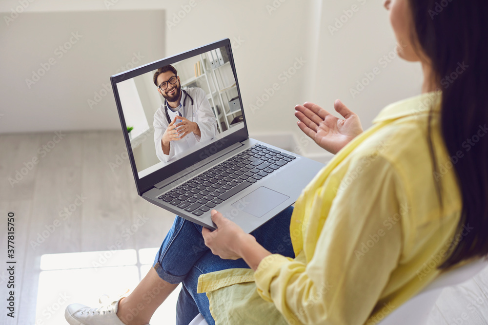 Fototapeta premium Doctor online. Young woman using video call and laptop to chat with doctor.