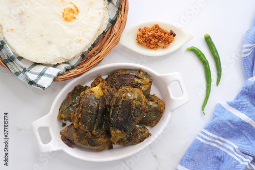 Indian, Maharashtrian side dish or appetizer Bharli Vangi, stuffed Eggplants, Crispy brinjal fry, Aubergine stuffed, served with Rice flour bhakri. copy space photo