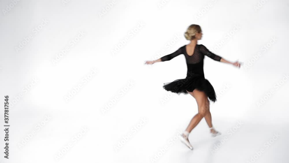 Young ballerina in skirt dancing classical ballet moves on white background