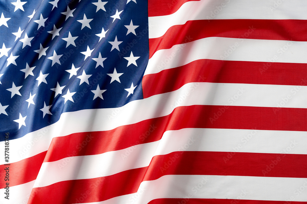 Fototapeta premium Close up of ruffled American flag. Satin texture curved flag of USA. Memorial Day or 4th of July. Banner, freedom concept