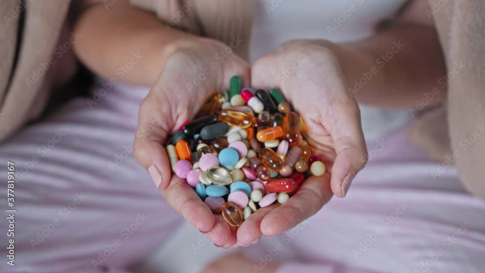 focus pull of pills in cupped hands on woman focus pull of pills in cupped hands on woman