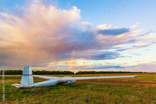 Plane on the airfield with beautiful cloud and rainbow