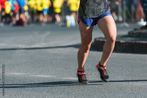Marathon running race. Close up of the many runners feet on road racing, sport competition, fitness and healthy lifestyle concept