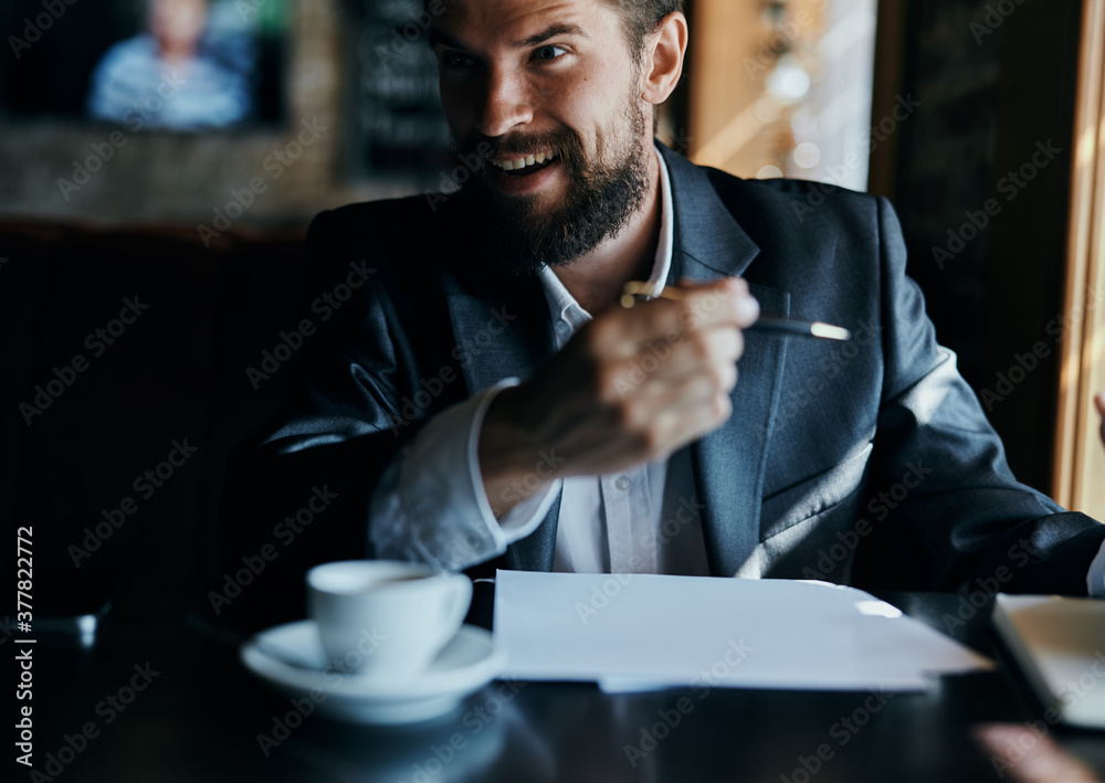 business man sitting at a table in a cafe documents work official coffee cup business man sitting at a table in a cafe documents work official coffee cup