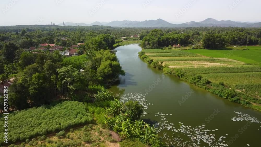 Drone view over rural village with lake, vegetables farm and rice fields. Drone view over rural village with lake, vegetables farm and rice fields.