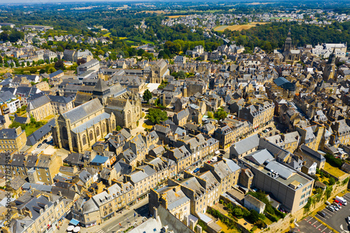 Scenic aerial view of summer cityscape of Dinan overlooking Gothic building of Catholic Church of Saint Malo, France