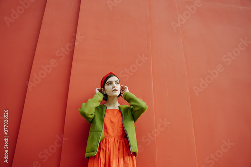 dreamy stylish trendy young girl in stylish clothes combination green and red. piercing mole above the lip on the face. Beautiful red and green bright saturated cheerful color mix. Conceptual artistic
