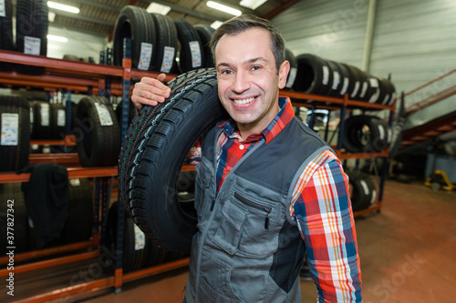 auto business owner and wheel tires at car service