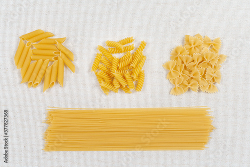 Italian foods concept and menu design. Various kind of Pasta on a linen fabric