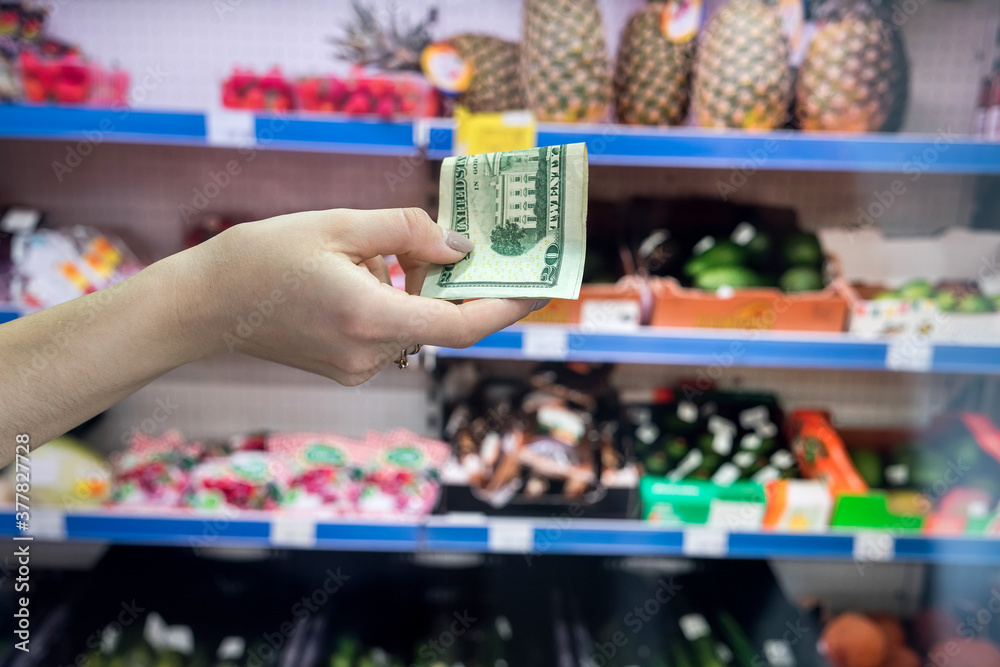 man holds dollars in the supermarket man holds dollars in the supermarket