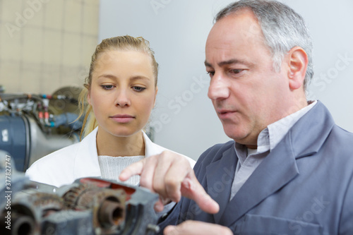 apprentice mechanic looking at engine