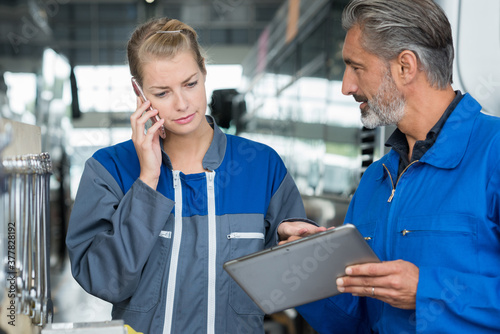 two engineers tablet monitoring in a factory photo