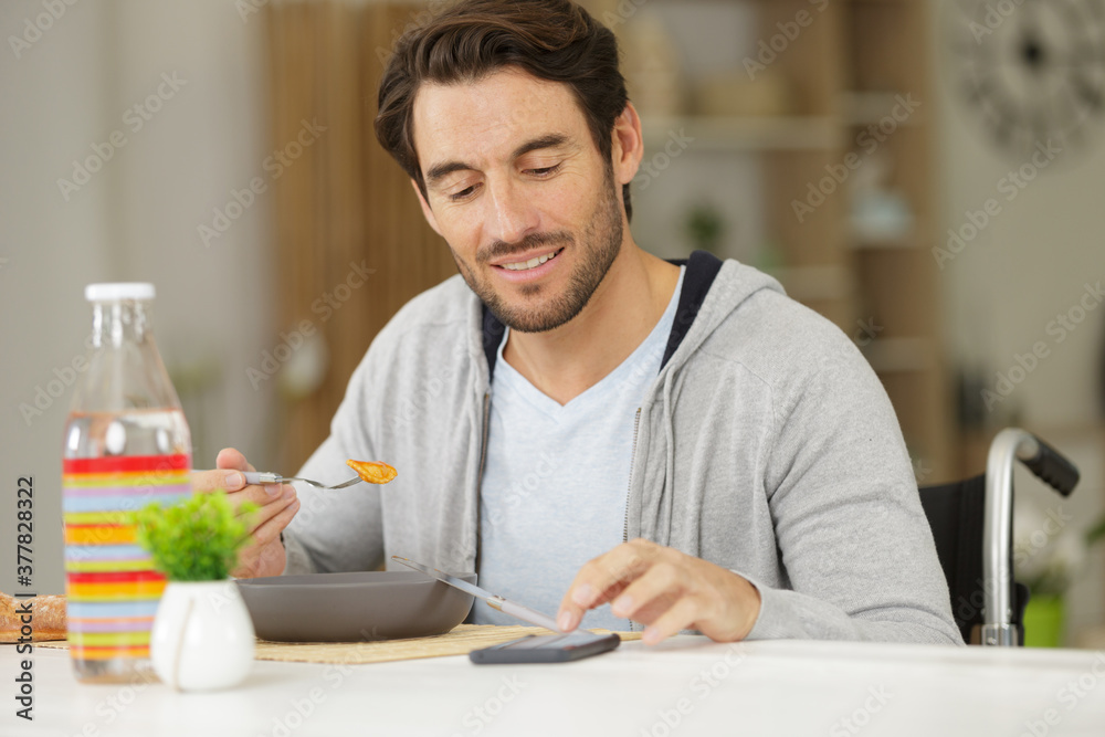 handsome man in wheelchair having a break handsome man in wheelchair having a break