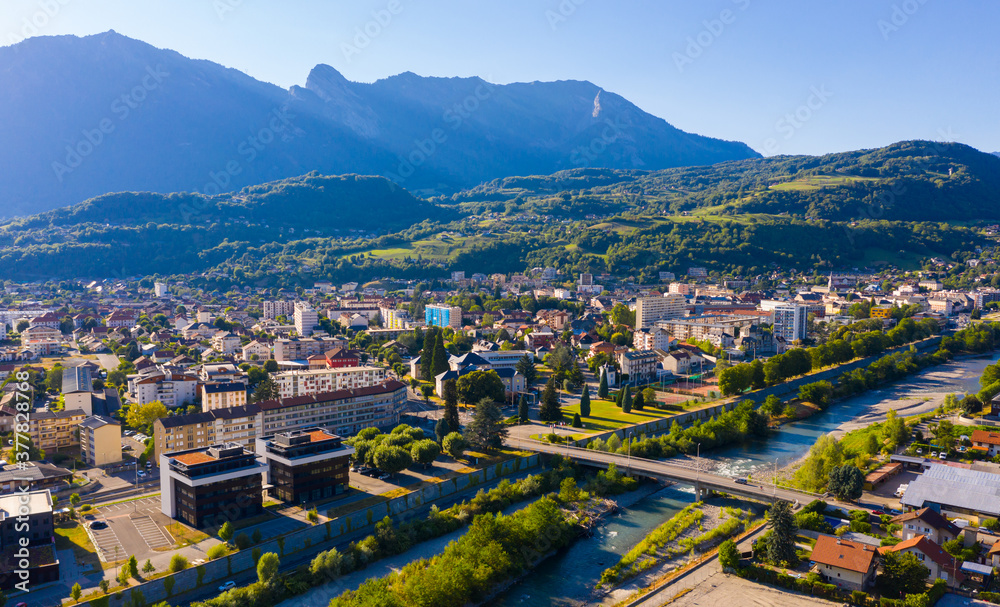 Scenic aerial view of French town of Albertville in green alpine valley on Arly River on sunny summer day