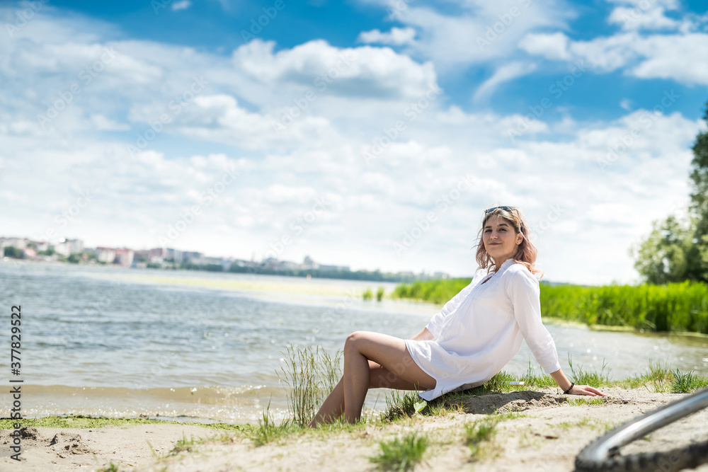  young beautiful woman in white dress enjoy nature near the lake, freedom