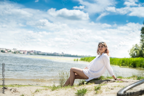  young beautiful woman in white dress enjoy nature near the lake, freedom