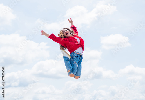 kid jump outdoor. kid fashion and beauty. sense of freedom. portrait of energetic child girl. concept of future. happy childhood. cheerful teen girl jumping high
