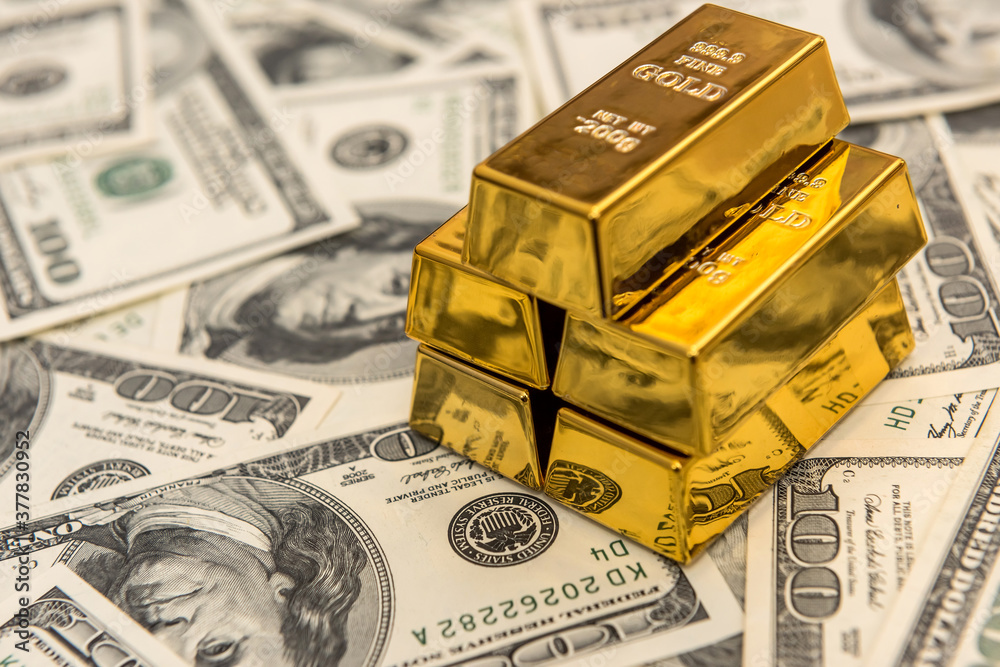 gold bars on the 100 dollar USD banknote as background gold bars on the 100 dollar USD banknote as background
