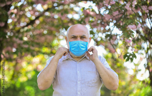 Wear mask. Pandemic concept. Limit risk infection spreading. Senior man wearing face mask. Older people at highest risk from covid-19. Mask protecting from virus. Elderly and other risk groups