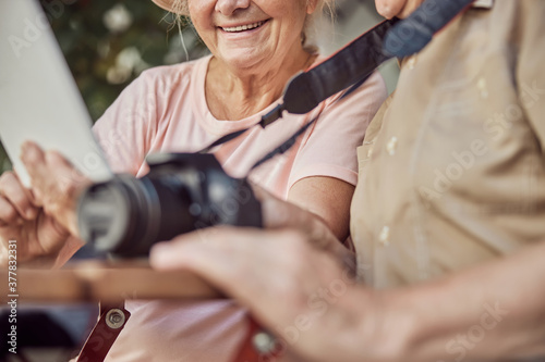 Modern elderly Caucasian couple using their gadgets