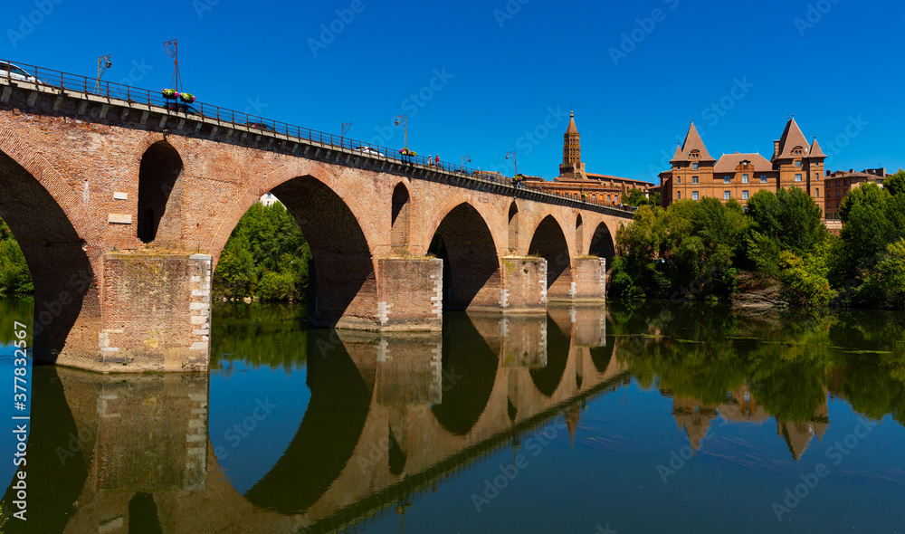 Montauban city on sunny day. Medieval bridge over the Tarn river. France