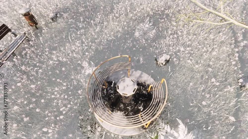 Empty playground roundabout surrounded at snow
