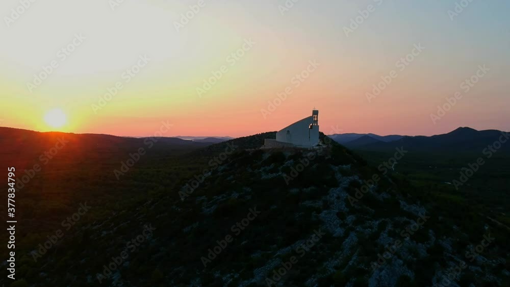 Aerial White church on Mediterranean hill during dramatic sunset in Croata Aerial White church on Mediterranean hill during dramatic sunset in Croata