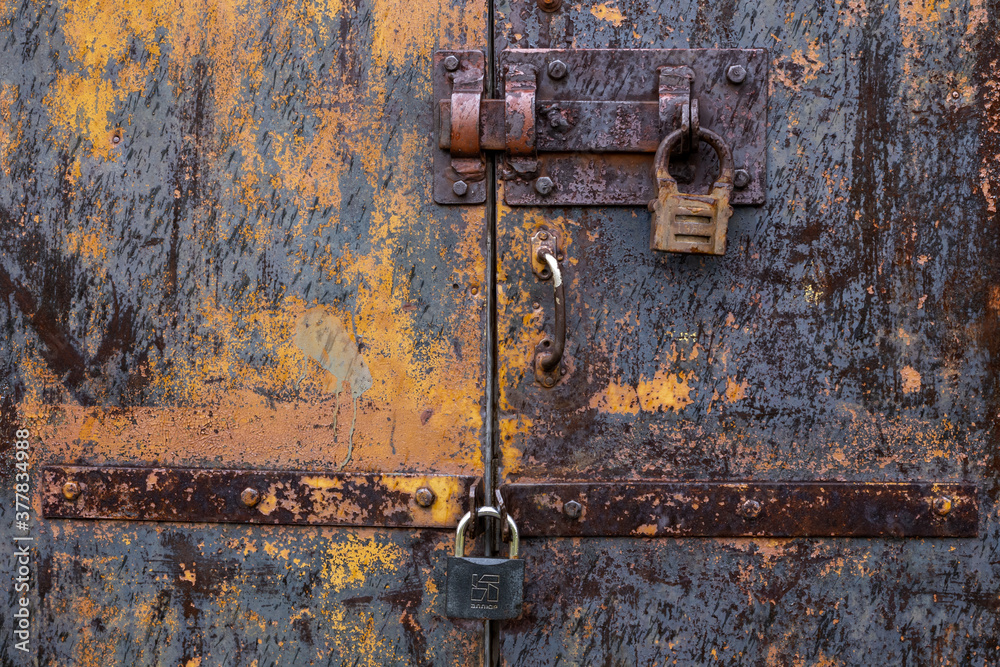 Old door with an old lock. Old padlock. Old door with an old lock. Old padlock.