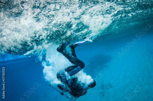scuba diver enters the water from a boat